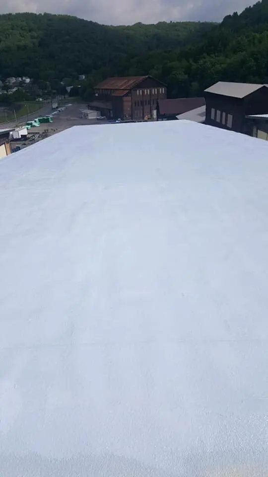 Aerial view of completed spray foam roofing project demonstrating seamless waterproof barrier installation with no seams or joints for maximum protection